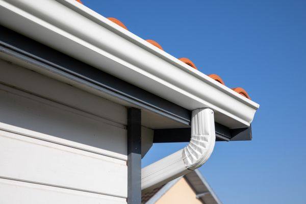 New white gutter and downspout on a house